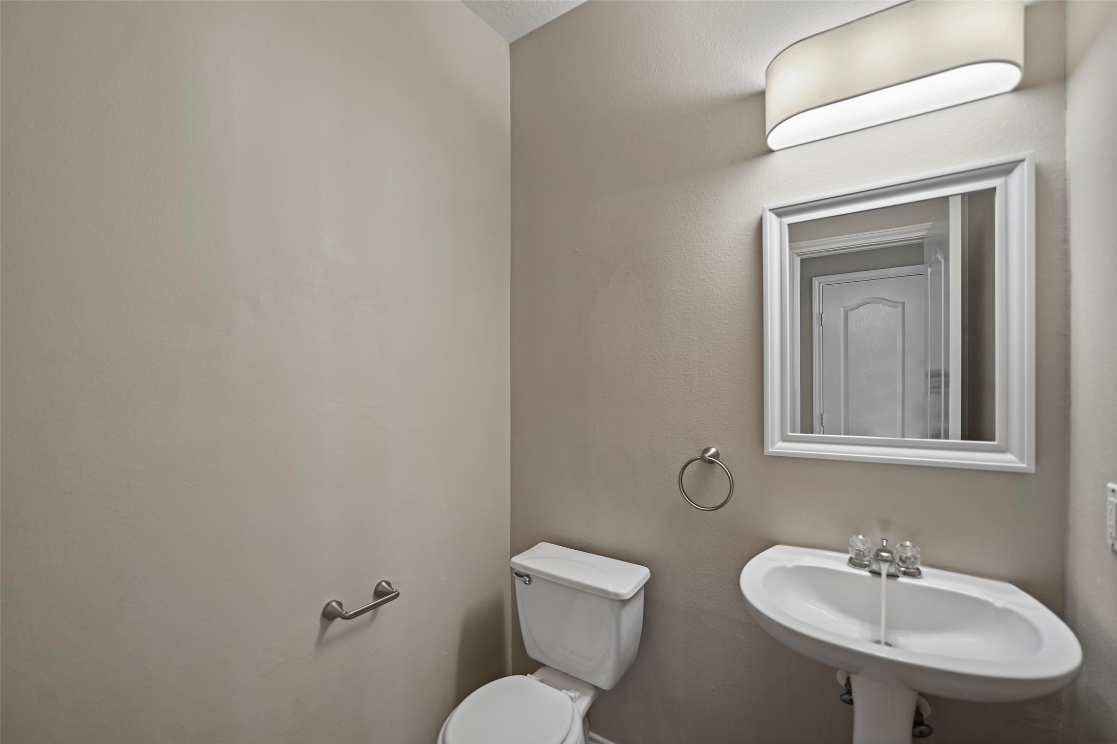 20739 Stewart Crest Lane Cypress, TX 77433 - Photo 13 of 35 a bathroom with a toilet sink and mirror