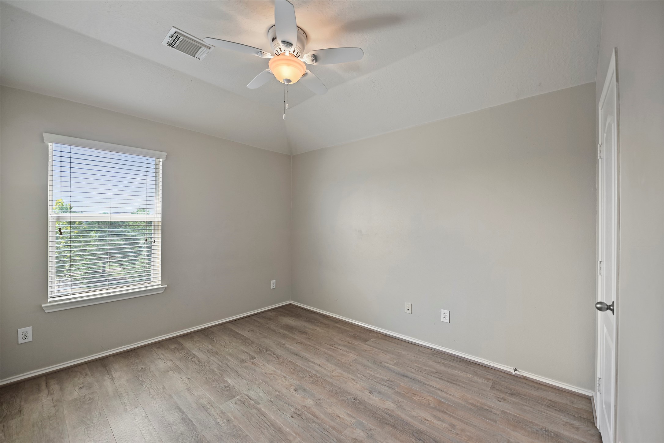 20739 Stewart Crest Lane Cypress, TX 77433 - Photo 17 of 35 wooden floor in an empty room with a window