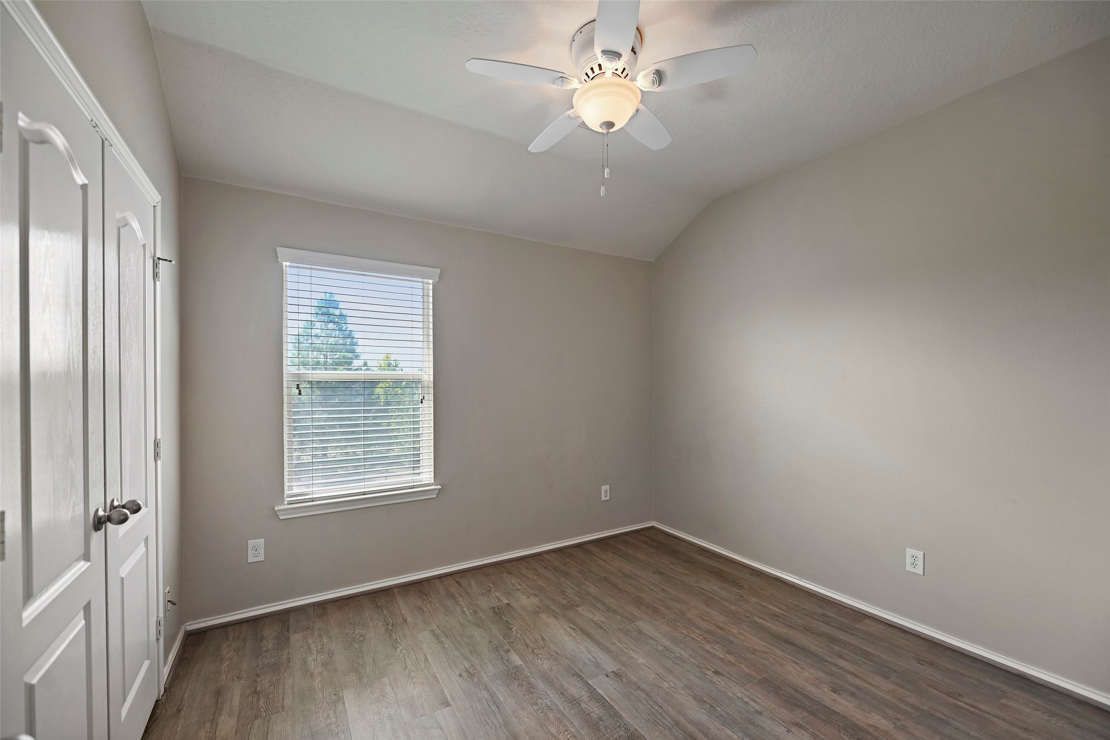 20739 Stewart Crest Lane Cypress, TX 77433 - Photo 19 of 35 an empty room with wooden floor fan and windows