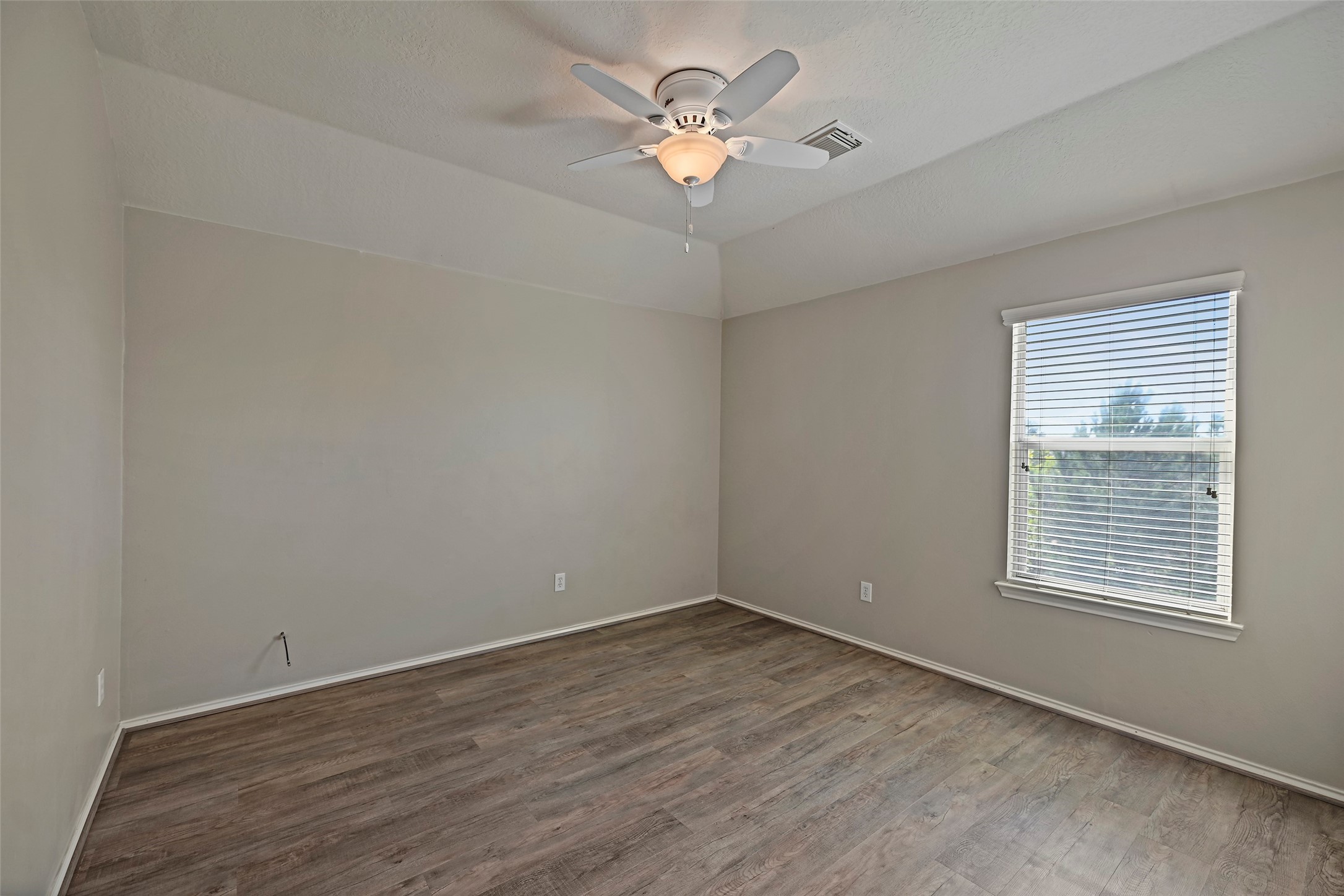 20739 Stewart Crest Lane Cypress, TX 77433 - Photo 21 of 35 wooden floor in an empty room with a window