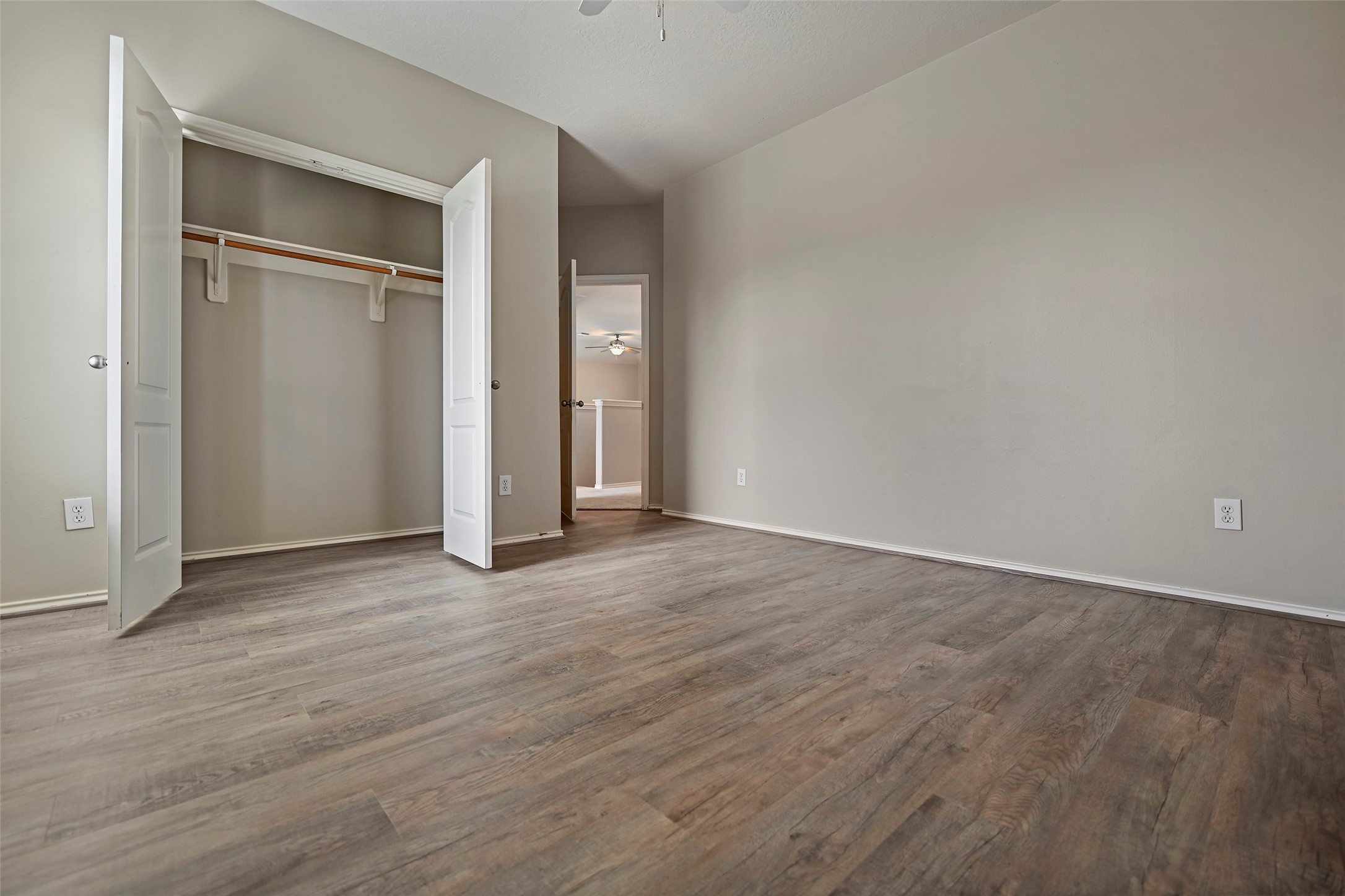 20739 Stewart Crest Lane Cypress, TX 77433 - Photo 22 of 35 an empty room with wooden floor closet and windows