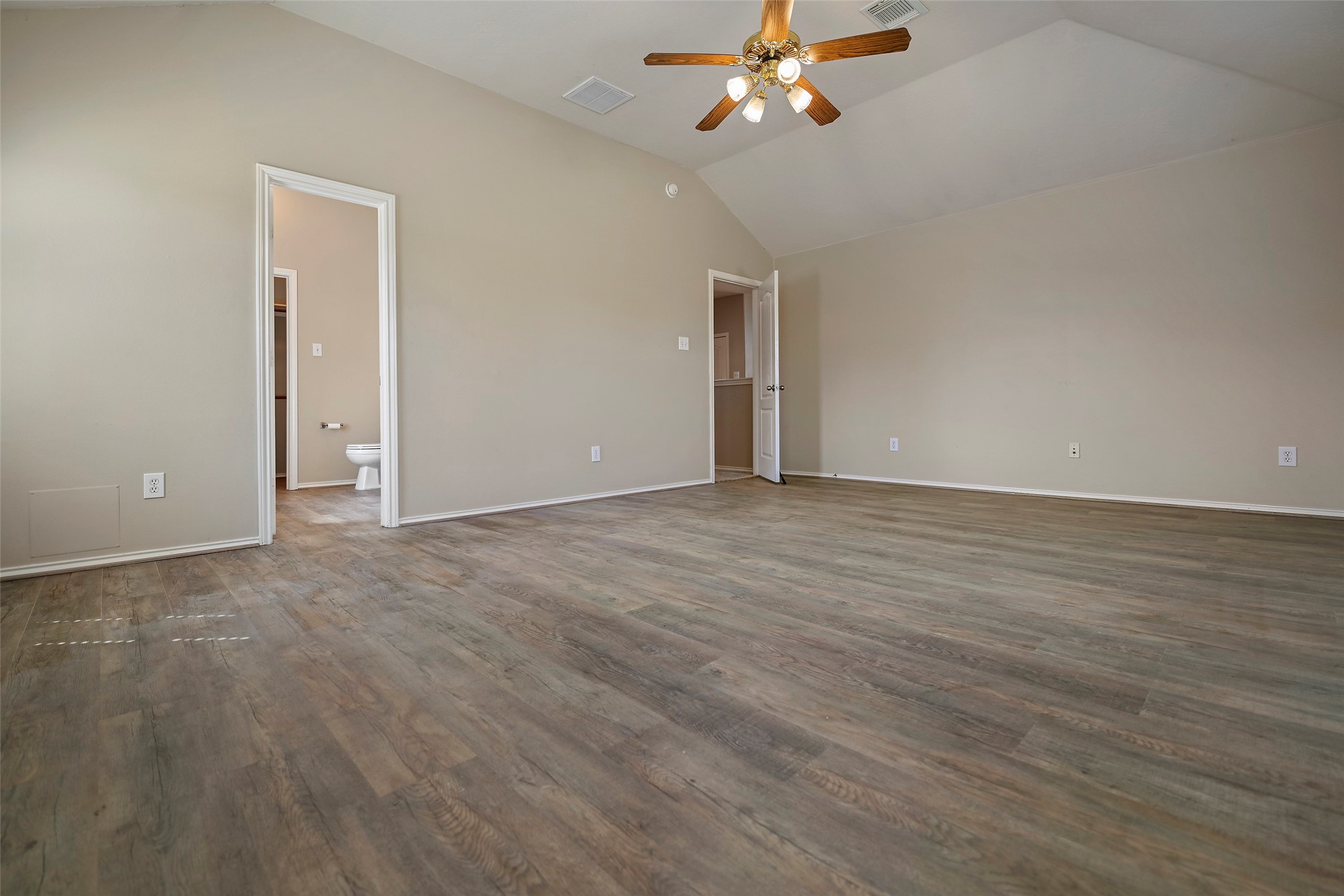 20739 Stewart Crest Lane Cypress, TX 77433 - Photo 26 of 35 a view of an empty room with chandelier fan and wooden floor