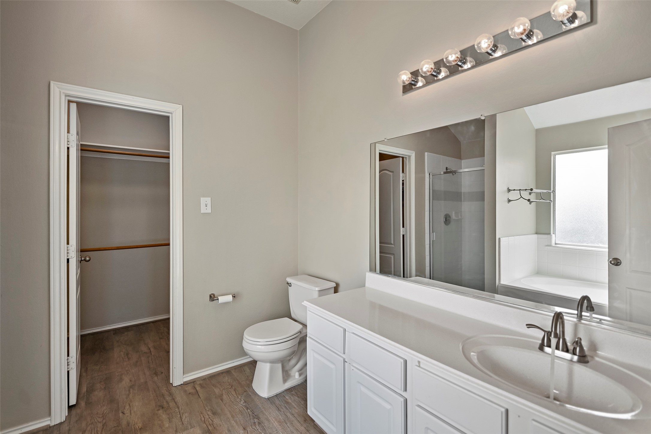 20739 Stewart Crest Lane Cypress, TX 77433 - Photo 27 of 35 a bathroom with a toilet a sink and a mirror