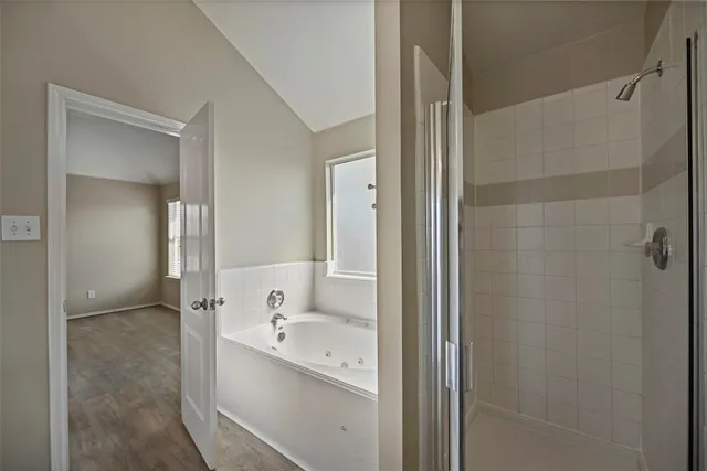 a bathroom with a bathtub and shower