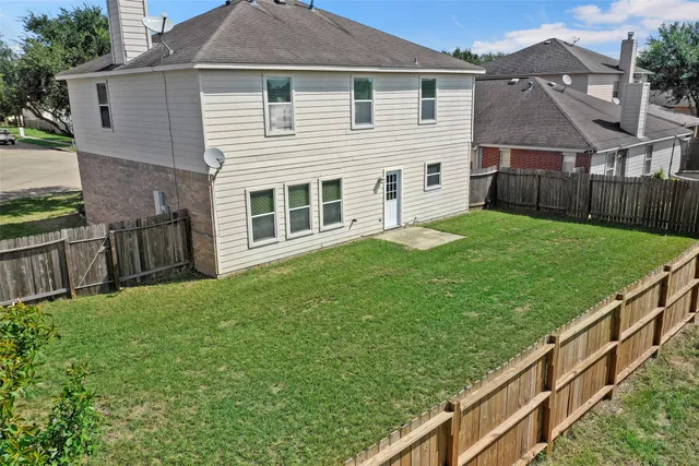 a view of a house with backyard and a garden