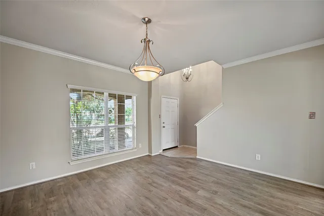 a view of a room with wooden floor and windows