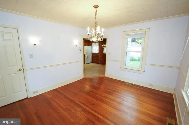 a view of livingroom with hardwood floor and kitchen view