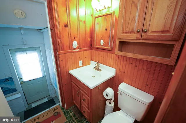 a bathroom with a sink a toilet and mirror