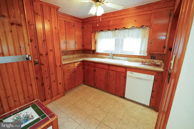 a kitchen with a sink cabinets and wooden floor