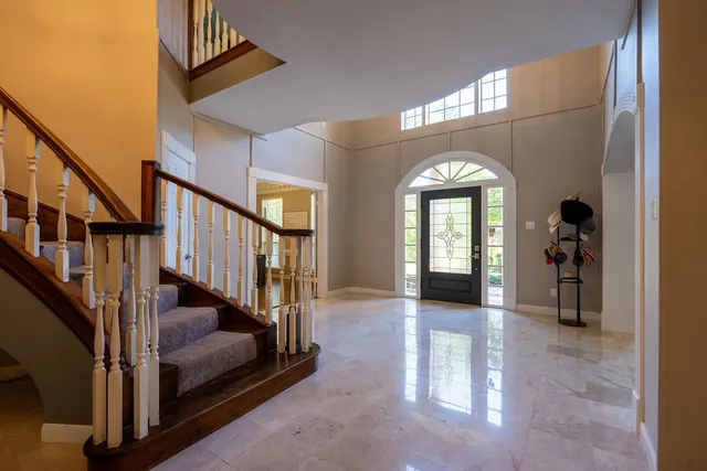 a view of entryway and hall with wooden floor