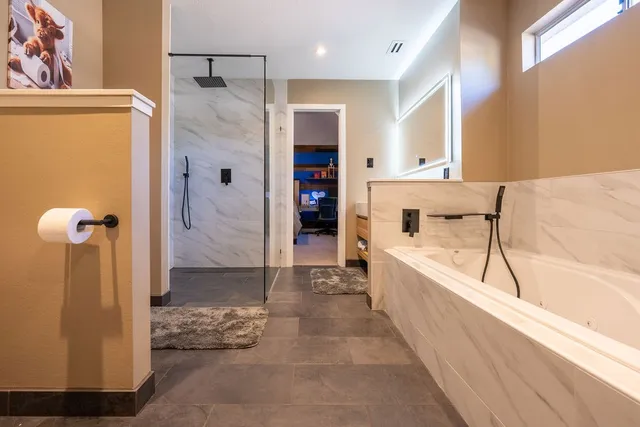 a bathroom with a bathtub and a shower