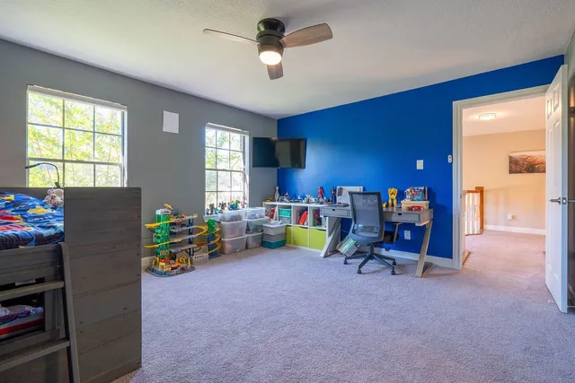 a view of a workspace with furniture and a window