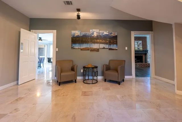 a living room with furniture and a chandelier