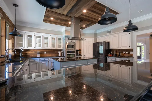 a kitchen with stainless steel appliances granite countertop a stove and a refrigerator