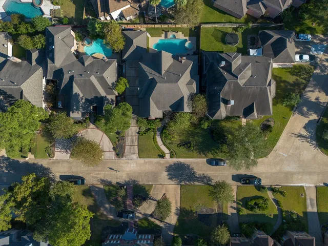 an aerial view of houses with yard