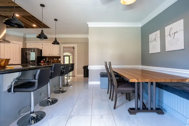 a dining room with a table and chairs