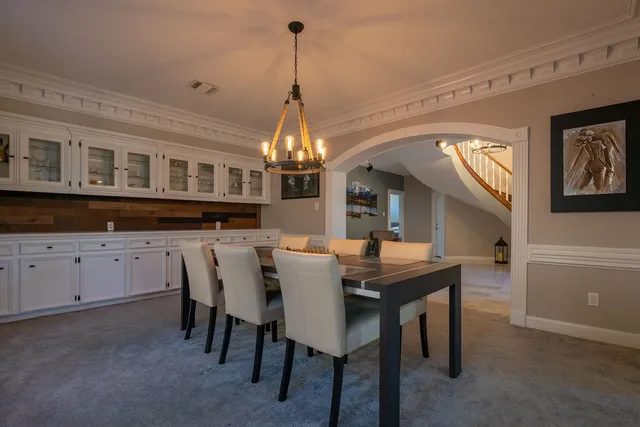 a view of a dining room with furniture and chandelier
