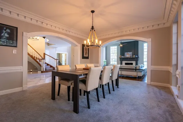 a view of a dining room with furniture and a chandelier
