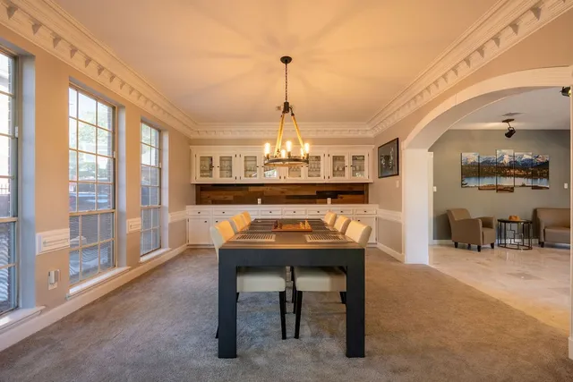 a view of a room with furniture and large windows