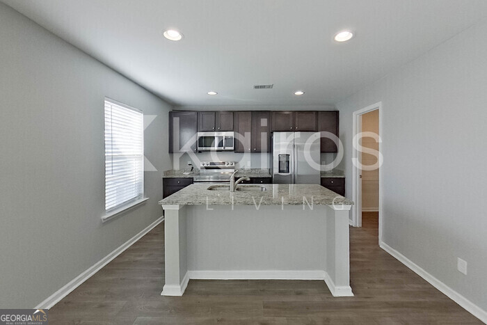 101 St Matthew Way Springfield, GA 31329 - Photo 6 of 30 a view of a kitchen with stainless steel appliances granite countertop a stove a sink dishwasher and a refrigerator
