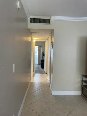 a view of a hallway with wooden shelves