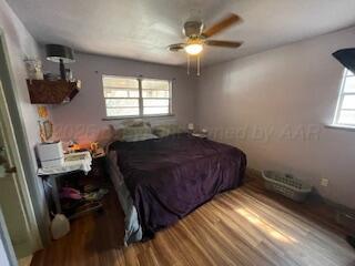 4515 South Bonham Street Amarillo, TX 79110 - Photo 17 of 21 a bedroom with a bed and a chandelier