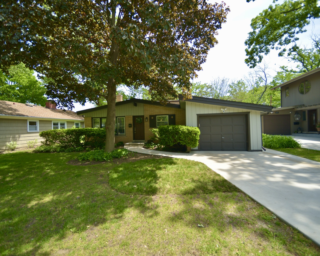 a front view of house with yard and green space