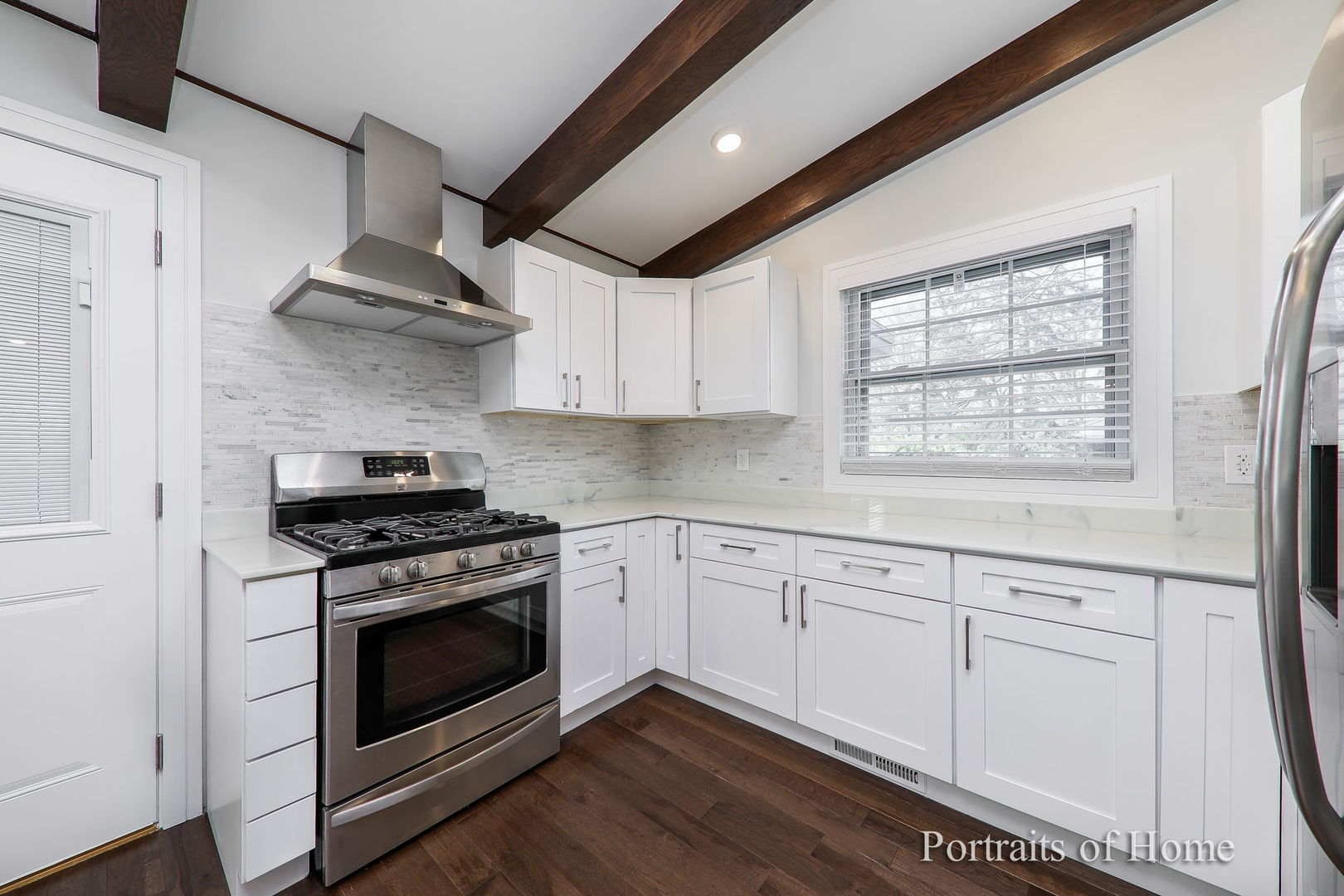 1181 Sherwood Road Highland Park, IL 60035 - Photo 7 of 22 a kitchen with white cabinets stainless steel appliances and sink