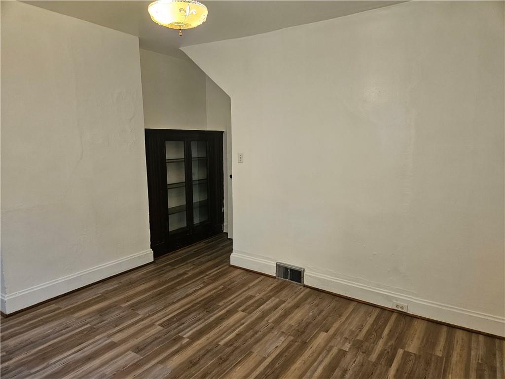 2212 Cronemeyer Street McKeesport, PA 15132 - Photo 12 of 48 a view of an empty room with wooden floor and a window