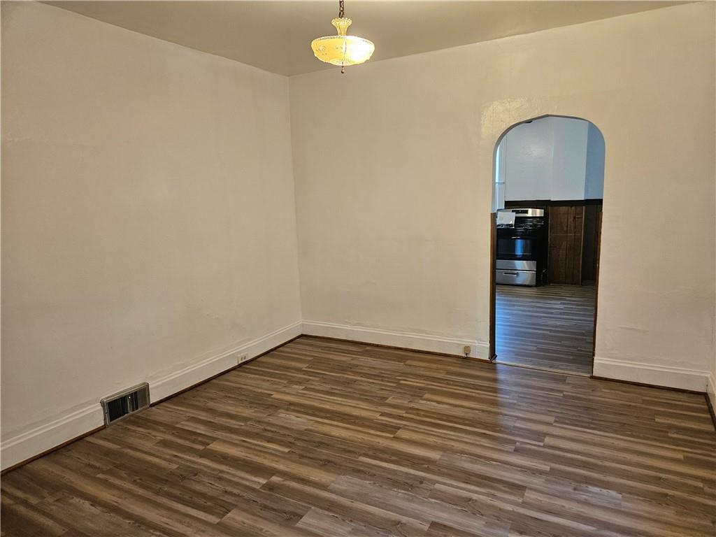 2212 Cronemeyer Street McKeesport, PA 15132 - Photo 14 of 48 a view of a livingroom with wooden floor and a ceiling fan