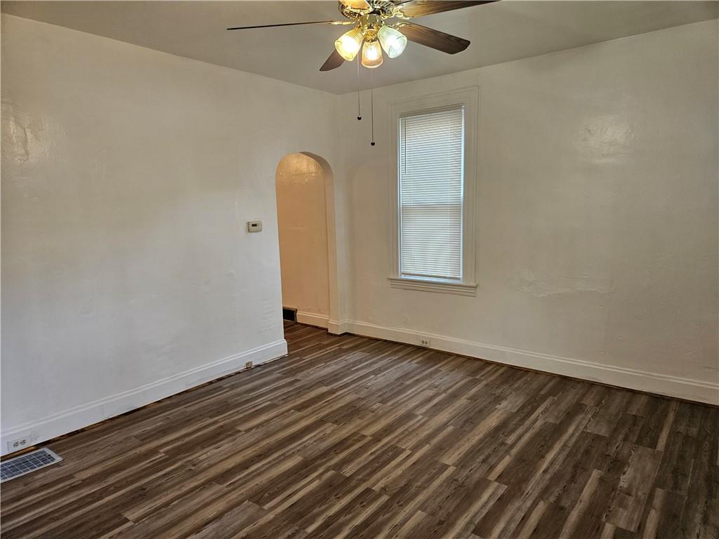 2212 Cronemeyer Street McKeesport, PA 15132 - Photo 19 of 48 an empty room with wooden floor fan and windows