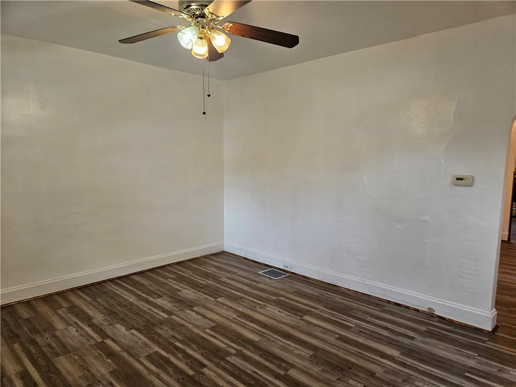 2212 Cronemeyer Street McKeesport, PA 15132 - Photo 20 of 48 a view of an empty room with wooden floor and a ceiling fan