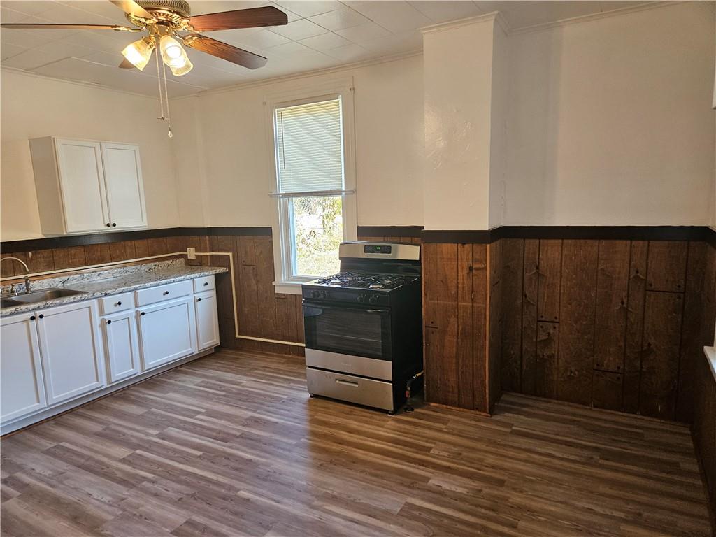 2212 Cronemeyer Street McKeesport, PA 15132 - Photo 5 of 48 a kitchen with wooden cabinets and white appliances