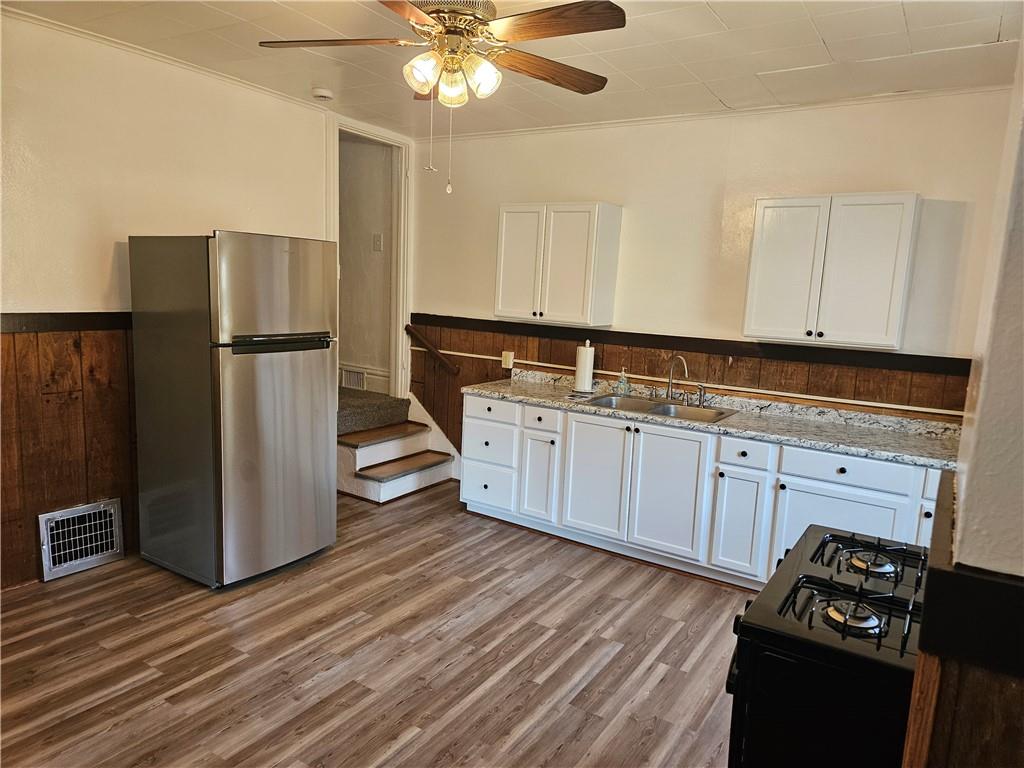 2212 Cronemeyer Street McKeesport, PA 15132 - Photo 8 of 48 a kitchen with stainless steel appliances a refrigerator and a stove
