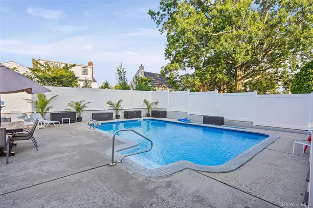 a view of swimming pool with seating space