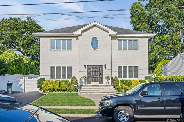 a front view of a house with a garden