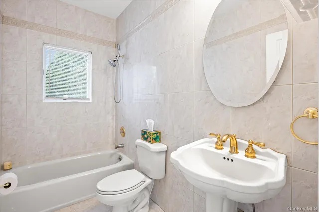 a bathroom with a sink a toilet and a bathtub