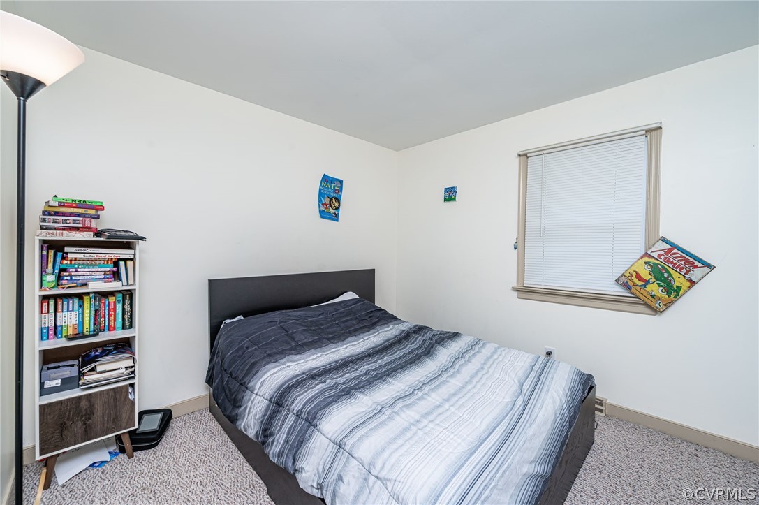 11420 Elshur Road Midlothian, VA 23112 - Photo 14 of 25 a bedroom with a bed and a book shelf
