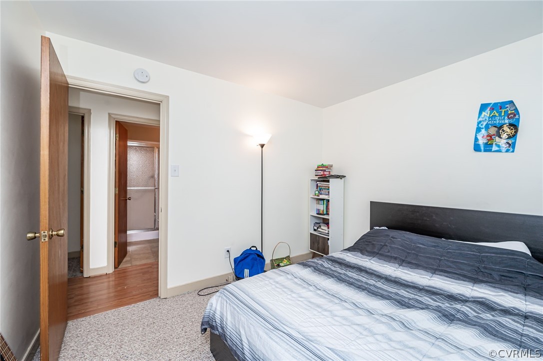 11420 Elshur Road Midlothian, VA 23112 - Photo 15 of 25 a bedroom with a bed and wooden floor