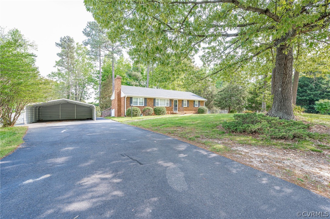 11420 Elshur Road Midlothian, VA 23112 - Photo 2 of 25 a front view of a house with garden