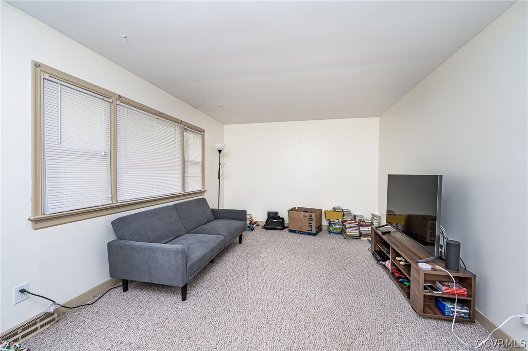 11420 Elshur Road Midlothian, VA 23112 - Photo 5 of 25 a living room with furniture and a flat screen tv