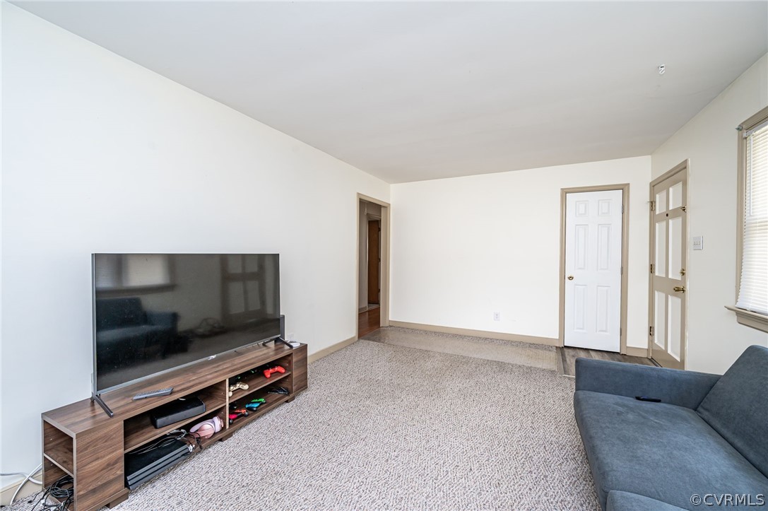 11420 Elshur Road Midlothian, VA 23112 - Photo 6 of 25 a living room with furniture and a flat screen tv