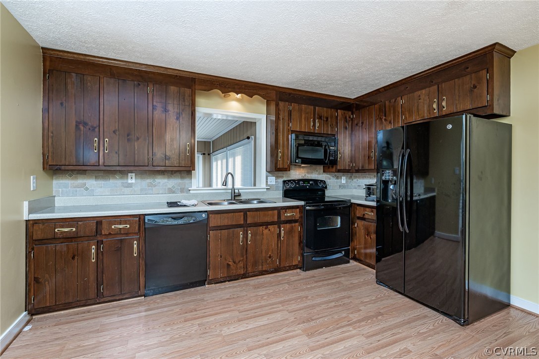 11420 Elshur Road Midlothian, VA 23112 - Photo 7 of 25 a kitchen with granite countertop wooden cabinets a refrigerator stove top oven and sink