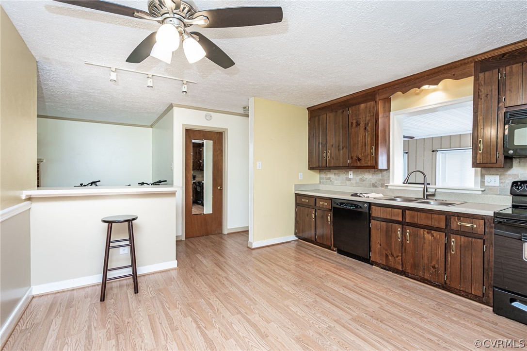 11420 Elshur Road Midlothian, VA 23112 - Photo 8 of 25 a large kitchen with cabinets wooden floor and stainless steel appliances