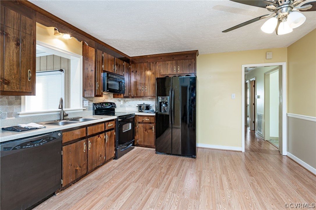 11420 Elshur Road Midlothian, VA 23112 - Photo 9 of 25 a kitchen with stainless steel appliances granite countertop a refrigerator a sink dishwasher a stove with wooden cabinets and floor