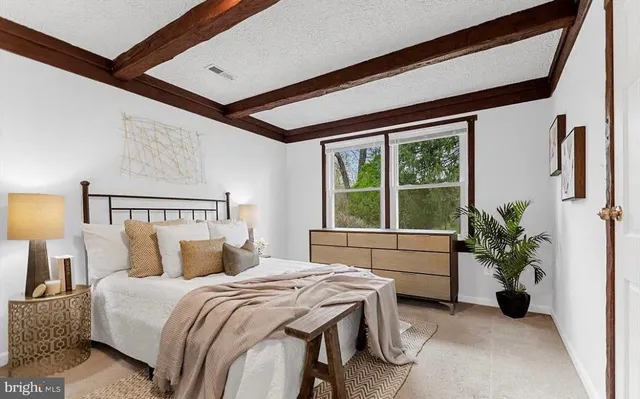 a bedroom with a bed and a potted plant