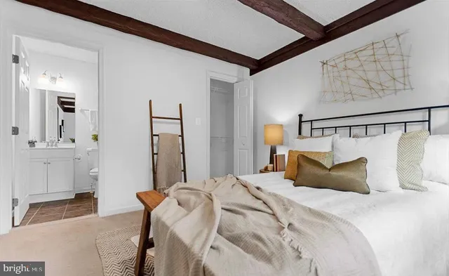 a bedroom with a bed and a mirror