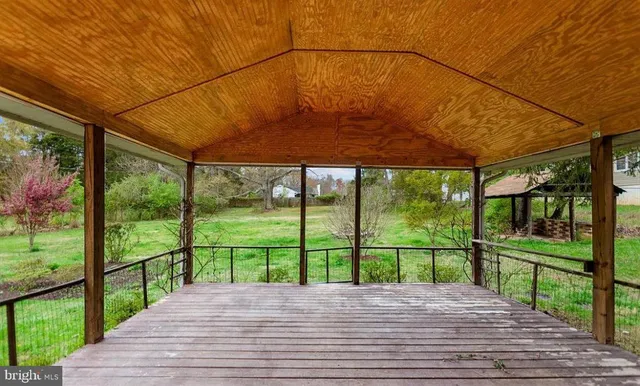 a view of a deck with a big yard