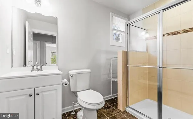 a bathroom with a toilet sink and a shower