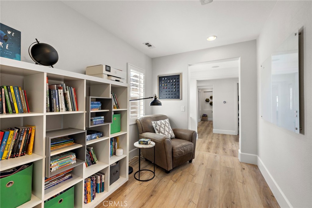 21 Snow Bush Street Ladera Ranch, CA 92694 - Photo 32 of 73 a living room with furniture and a book shelf